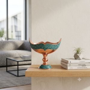 Turquoise inlaying Kashkool dish displayed on a wooden floating shelf beside books.