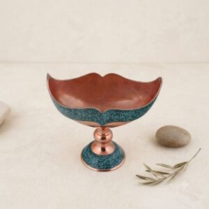 Top angle view of the interior polished copper rim of a turquoise inlaying Kashkool dish.