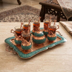 Handmade Persian turquoise inlaying FiroozeKoobi tea set with tea-filled glasses on an engraved copper tray.