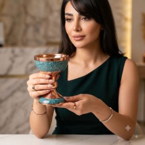 Woman holding a handcrafted turquoise inlaying copper Sangab dish in an elegant setting.