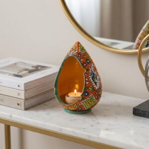 Hamedan enamel pottery tealight holder sitting on a marble console table beside a mirror.