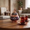 Handcrafted Copper and Pardaz sugar bowl on a wooden coffee table next to Persian tea cups.