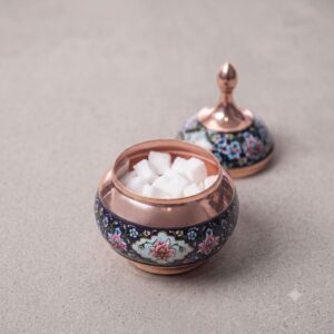 Open Copper and Pardaz sugar bowl filled with white sugar cubes on a neutral surface.