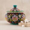 Handmade Hamedan enamel pottery sugar bowl next to sugar cubes and brass tongs.