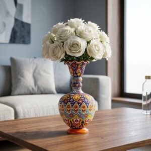 Hamedan enamel pottery vase filled with white roses on a modern coffee table.