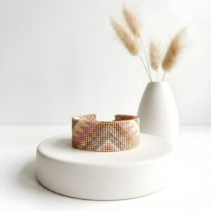 Artisan Blush Chevron loom cuff bracelet displayed elegantly on a minimalist white pedestal.