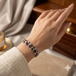 Close-up shot of the sophisticated brown and white glass seed bead bracelet showcased beautifully on a woman's wrist.