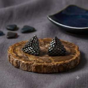 Professional woman in black blazer wearing gold-toned black triangle beaded earrings