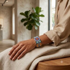 Model wearing the artisan geometric mosaic woven cuff bracelet with beige linen outfit.