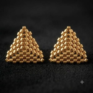 Macro close-up of handmade 3D gold-toned beaded triangle stud earrings.