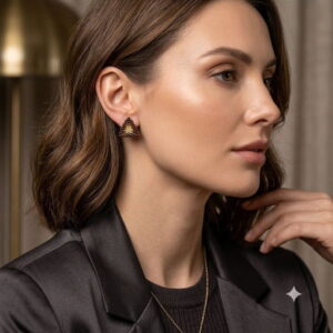 Model showcasing handmade gold-colored geometric statement earrings.