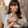 Model wearing handmade gold-toned and black geometric beaded earrings and matching cuff bracelet.