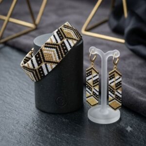 Handcrafted optical cube beaded bracelet and earrings on frosted acrylic display stand.