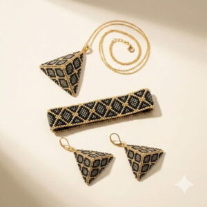 Flat-lay of 3D pyramid necklace, cuff, and earrings with gold-colored accents.