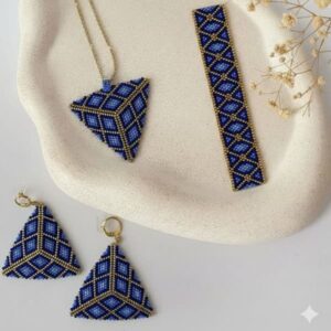 Flat lay view of the geometric beaded jewelry set showcasing the brilliant gold hues and intricate beadwork pattern.