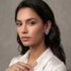 Model wearing hand-woven periwinkle beaded triangle stud earring styled with white blouse.