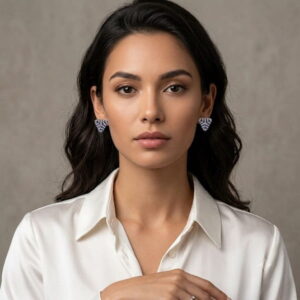Frontal portrait of model wearing matching periwinkle beaded triangle earrings.