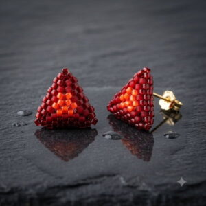 Back detail of red 3D beaded triangle stud earrings with gold-toned post finding on slate.