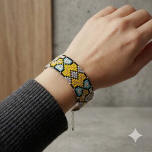 Detailed view of a lightweight handmade artisan bead cuff bracelet on a woman's wrist.